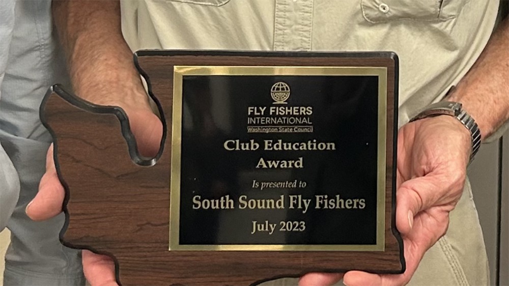 A person holding a plaque Description automatically generated